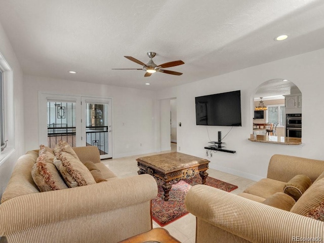 tiled living room featuring ceiling fan