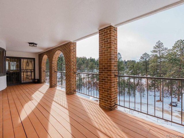 snow covered deck with a water view