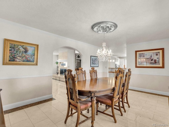 dining room with ornamental molding and a textured ceiling