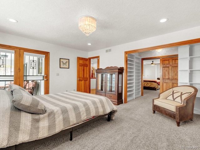 carpeted bedroom featuring a textured ceiling