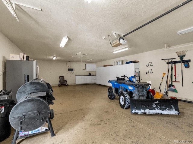 garage with a garage door opener and refrigerator