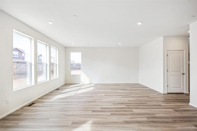 empty room with light hardwood / wood-style flooring