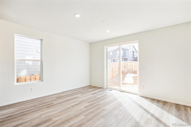 unfurnished room with light hardwood / wood-style flooring