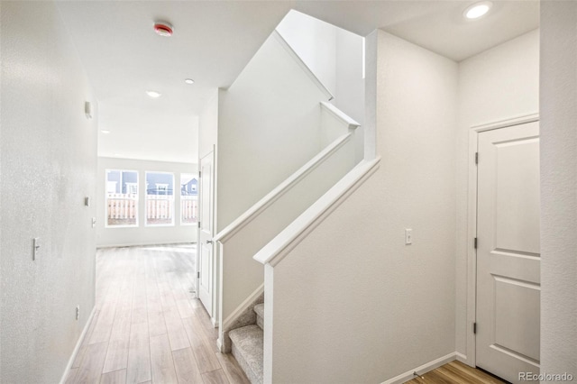 stairs with hardwood / wood-style flooring