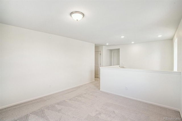 unfurnished room featuring light colored carpet