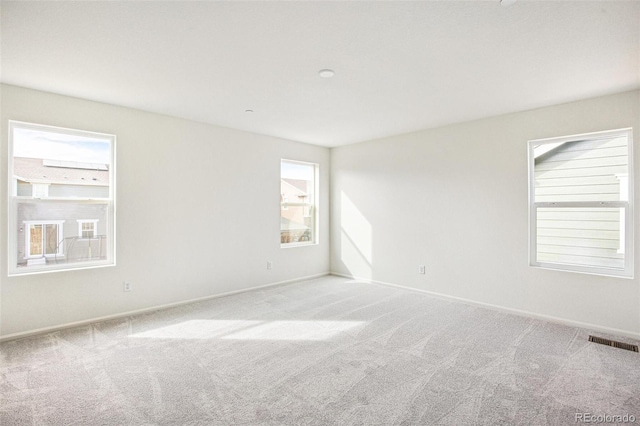 spare room with light colored carpet