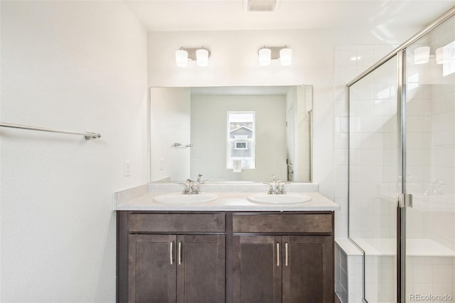 bathroom with walk in shower and vanity