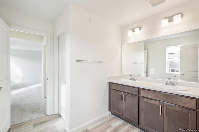 bathroom with vanity and hardwood / wood-style floors