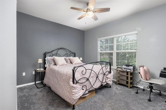 carpeted bedroom with ceiling fan and baseboards