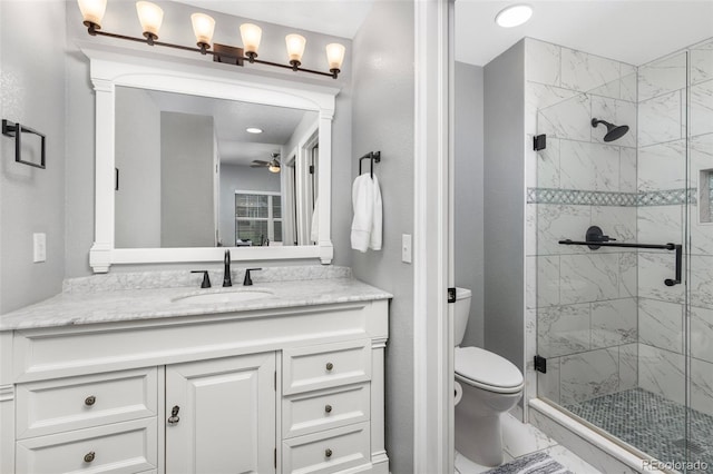 bathroom featuring a stall shower, a ceiling fan, and toilet
