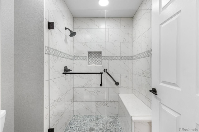bathroom featuring a shower stall and toilet