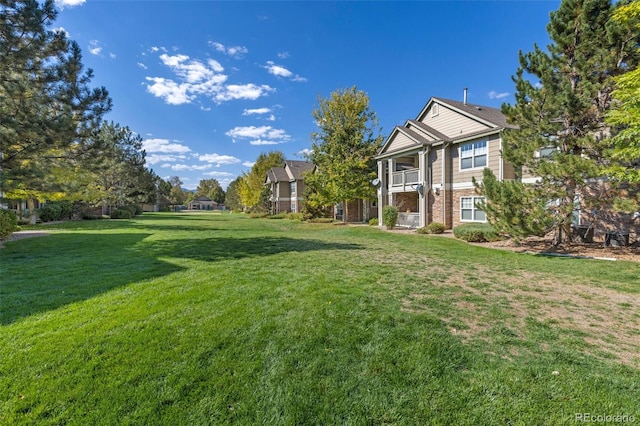 4385 S Balsam St Unit 10-103, Littleton, CO 80123 - view of grassy yard with a balcony