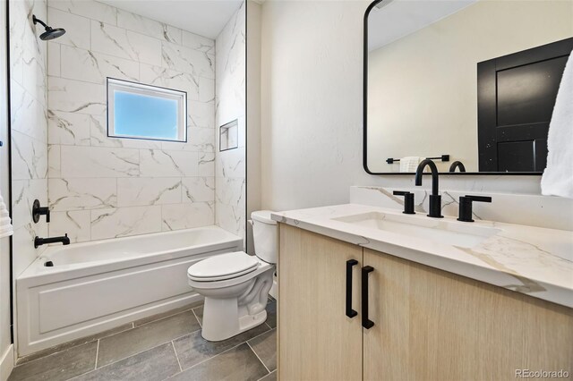 full bathroom featuring toilet, vanity, and tiled shower / bath