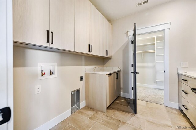 laundry area featuring washer hookup, hookup for an electric dryer, and cabinets