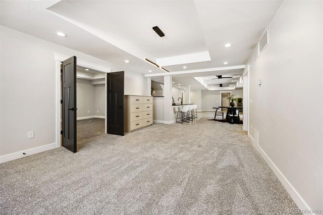 basement with carpet flooring and ceiling fan