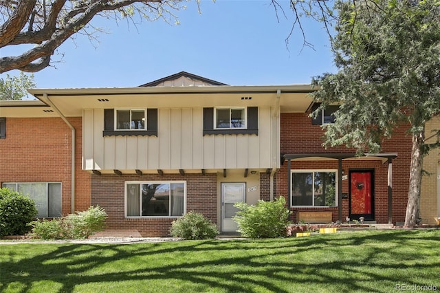 12455 W Alameda Dr, Lakewood, CO 80228 - view of front of house with a front lawn, board and batten siding, and brick siding