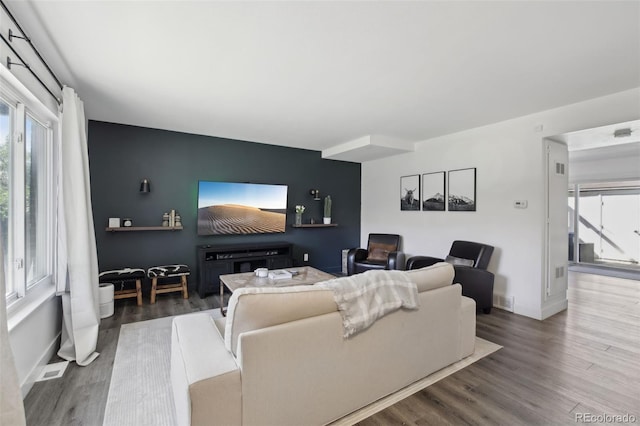 12455 W Alameda Dr, Lakewood, CO 80228 - living room with wood finished floors, plenty of natural light, baseboards, and an accent wall