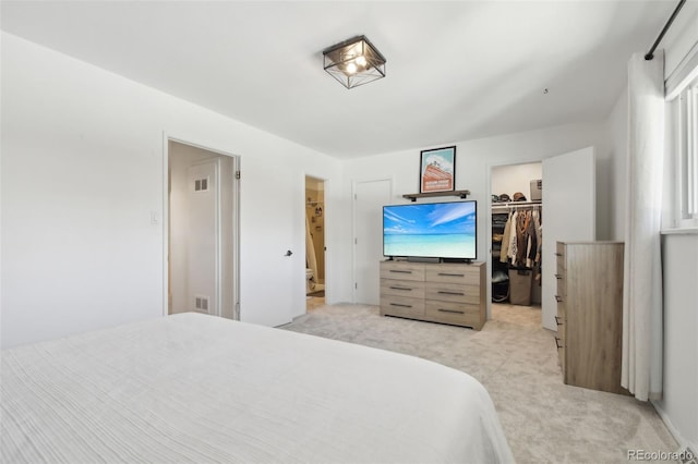 12455 W Alameda Dr, Lakewood, CO 80228 - bedroom featuring light carpet, a walk in closet, a closet, and ensuite bathroom