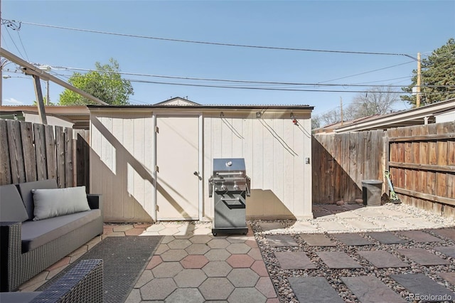 12455 W Alameda Dr, Lakewood, CO 80228 - view of shed featuring a fenced backyard and an outdoor living space