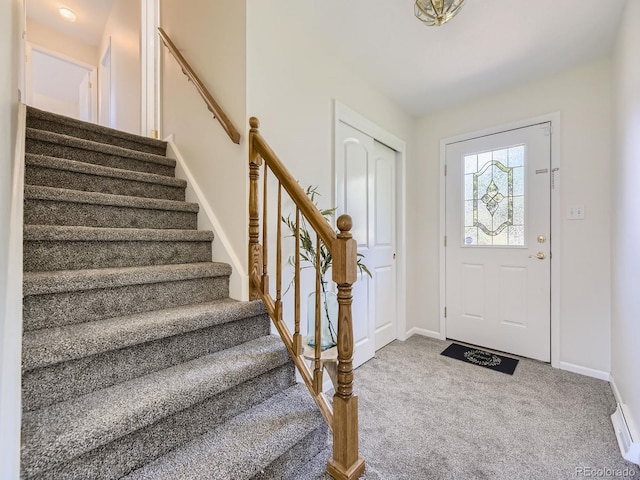 view of carpeted foyer entrance