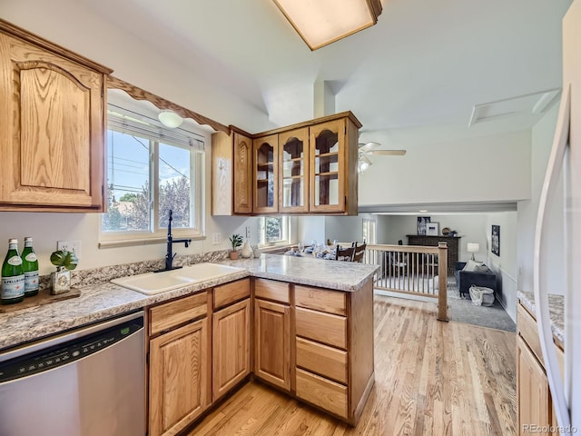 kitchen featuring dishwasher, kitchen peninsula, sink, ceiling fan, and light hardwood / wood-style floors