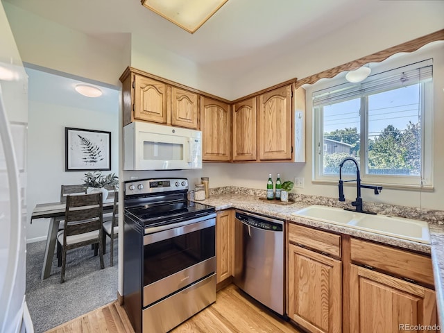 kitchen with light hardwood / wood-style flooring, sink, and appliances with stainless steel finishes