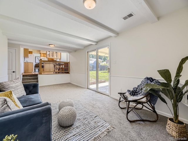 living room featuring carpet and beam ceiling