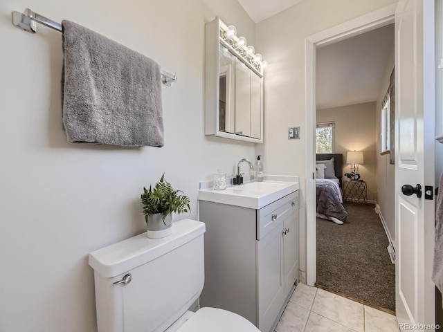 bathroom with vanity, toilet, and tile patterned flooring