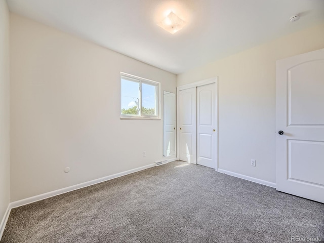 unfurnished bedroom with a closet and carpet floors