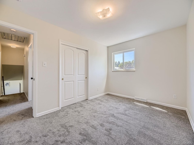 unfurnished bedroom with a closet and carpet