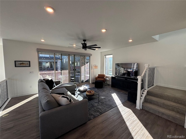 living room with dark hardwood / wood-style flooring and ceiling fan