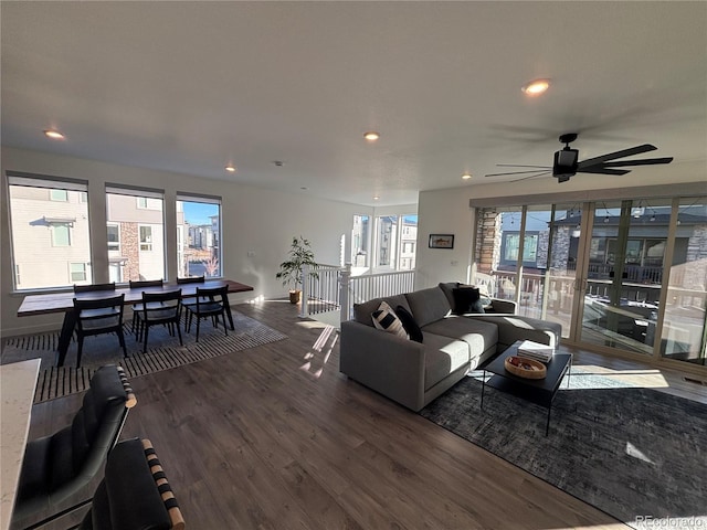 living room with ceiling fan and dark wood-type flooring