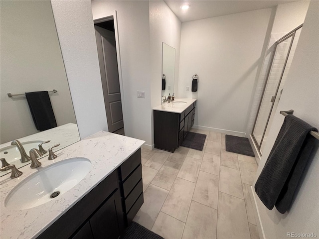 bathroom with vanity and a shower with door