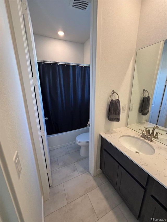 full bathroom featuring tile patterned flooring, shower / tub combo, vanity, and toilet