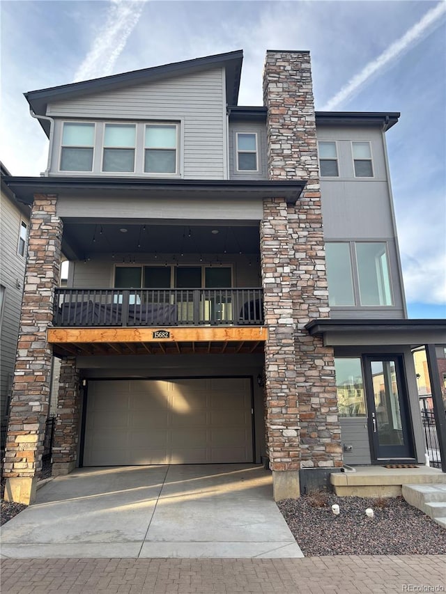 contemporary home featuring a balcony and a garage