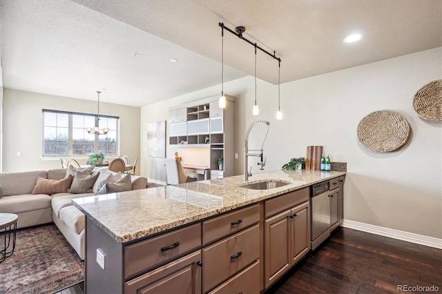 kitchen with sink, light stone counters, stainless steel dishwasher, dark hardwood / wood-style floors, and kitchen peninsula