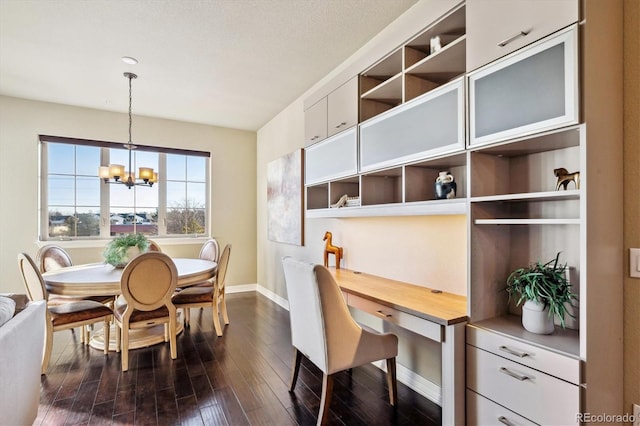 dining area with dark hardwood / wood-style floors and a chandelier