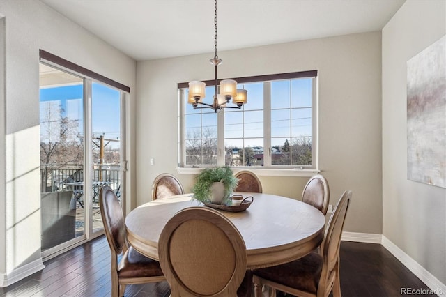 dining room featuring a notable chandelier and dark hardwood / wood-style flooring