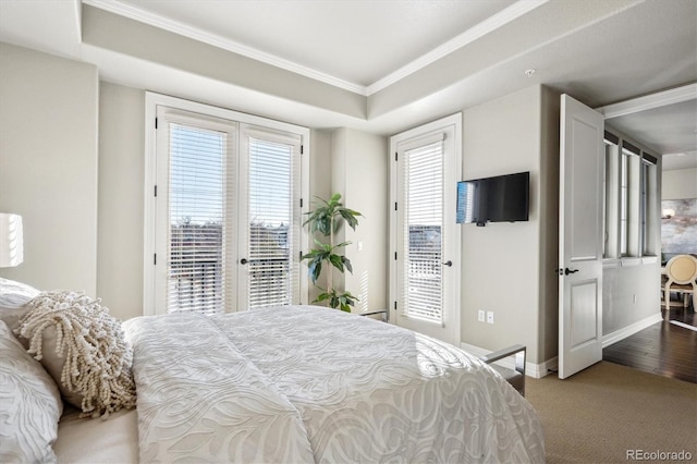 bedroom featuring carpet floors, crown molding, access to outside, and a raised ceiling