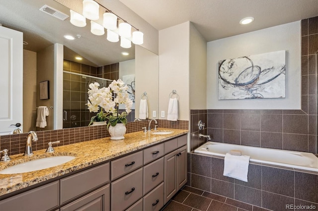 bathroom featuring vanity, independent shower and bath, tile patterned flooring, and backsplash