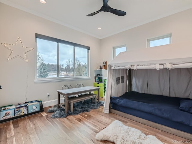 bedroom featuring ceiling fan, crown molding, and wood-type flooring