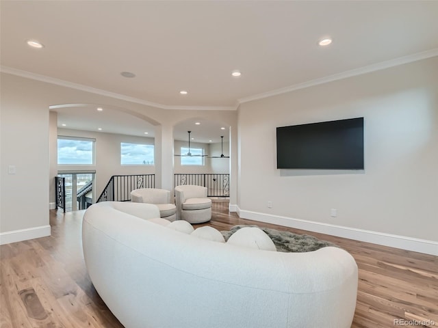 living room featuring light hardwood / wood-style floors and crown molding