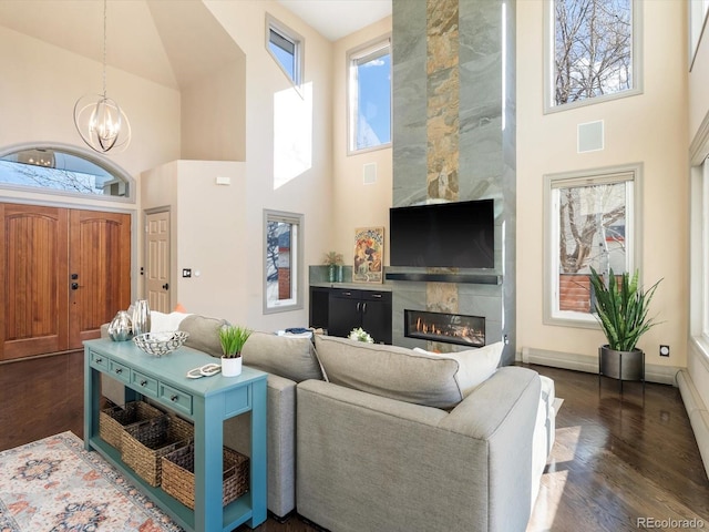 4825 6th St, Boulder, CO 80304 - living area with a high ceiling, a chandelier, dark wood-style floors, a premium fireplace, and baseboard heating