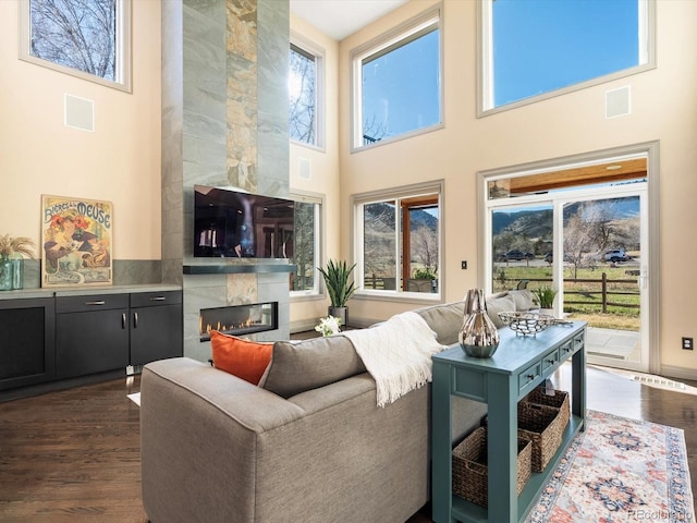 4825 6th St, Boulder, CO 80304 - living room featuring a high ceiling, dark wood-style flooring, and a high end fireplace
