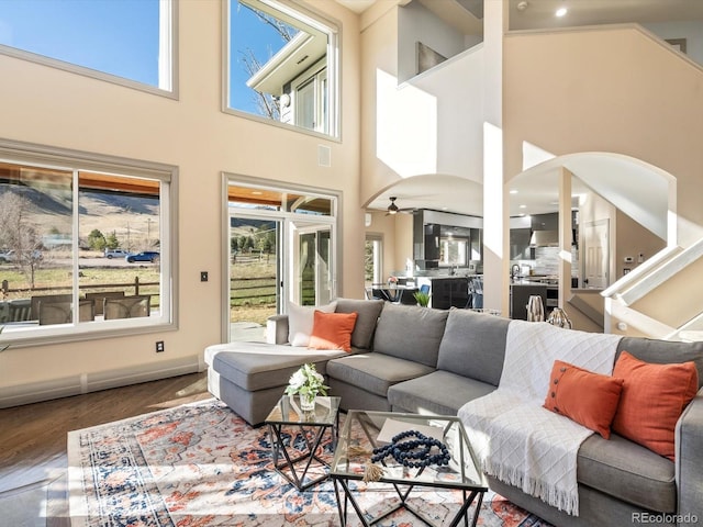 4825 6th St, Boulder, CO 80304 - living room featuring wood finished floors, a towering ceiling, and arched walkways