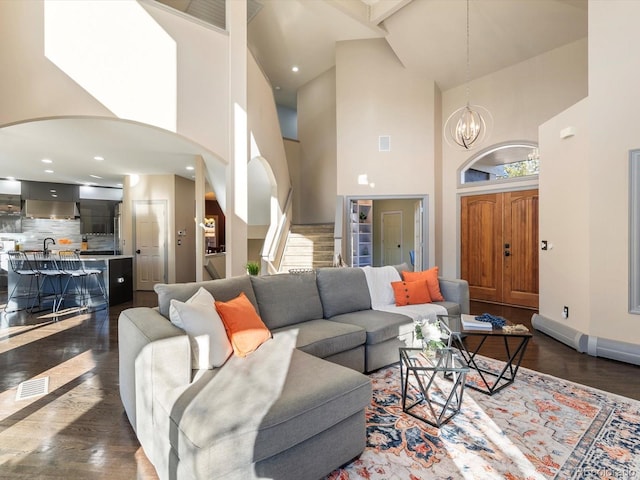 4825 6th St, Boulder, CO 80304 - living area featuring high vaulted ceiling, arched walkways, a chandelier, and dark wood-style floors