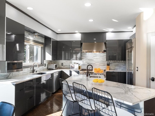4825 6th St, Boulder, CO 80304 - kitchen featuring modern cabinets, a kitchen bar, dark cabinetry, light stone counters, and recessed lighting