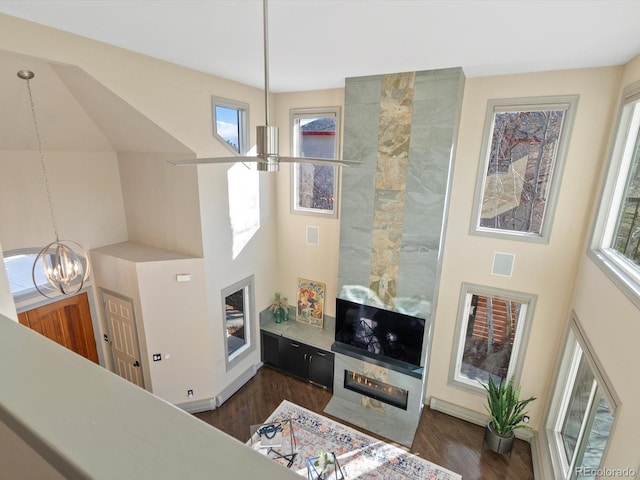 4825 6th St, Boulder, CO 80304 - living room with dark wood finished floors, plenty of natural light, a towering ceiling, and a chandelier