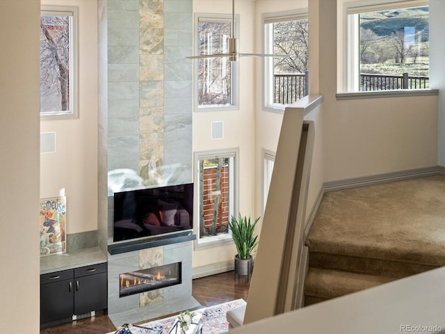 4825 6th St, Boulder, CO 80304 - living room featuring a tile fireplace and baseboards