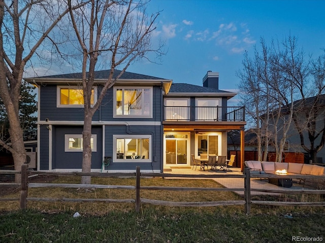 4825 6th St, Boulder, CO 80304 - rear view of house with a fenced backyard, a chimney, and an outdoor living space with a fire pit